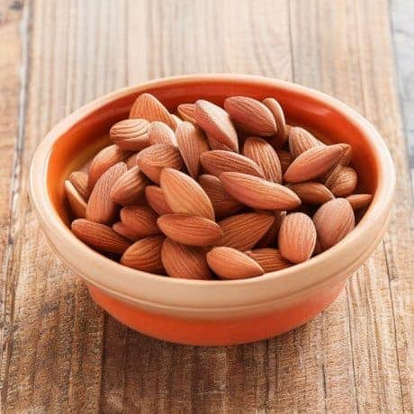 almonds in orange ceramic bowl